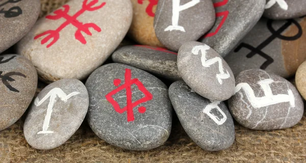 Fortune telling with symbols on stones on burlap background — Stock Photo, Image