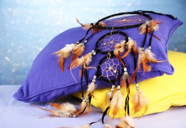 Beautiful dream catcher and pillows on blue background clipart