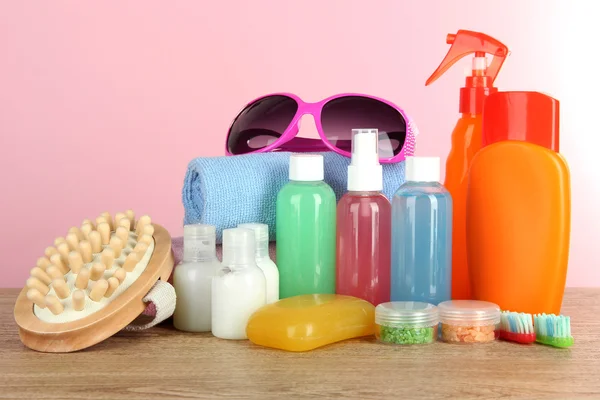 Hotel amenities kit on table on pink background — Stock Photo, Image