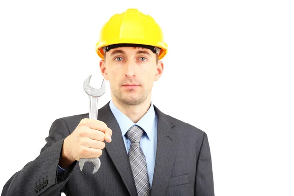 Young businessman in helmet with wrench — Stock Photo, Image