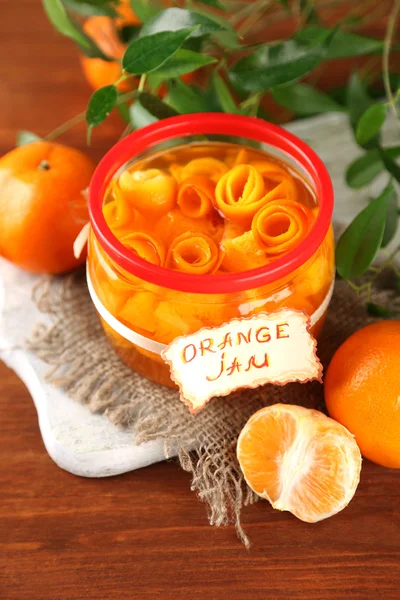 Orange jam with zest and tangerines, on brown wooden table — Stock Photo, Image