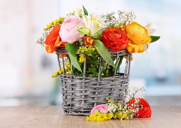 Many different flowers in basket on room background — Stock Photo, Image