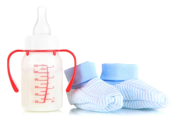 Bottle for milk formula with booties isolated on white — Stock Photo, Image