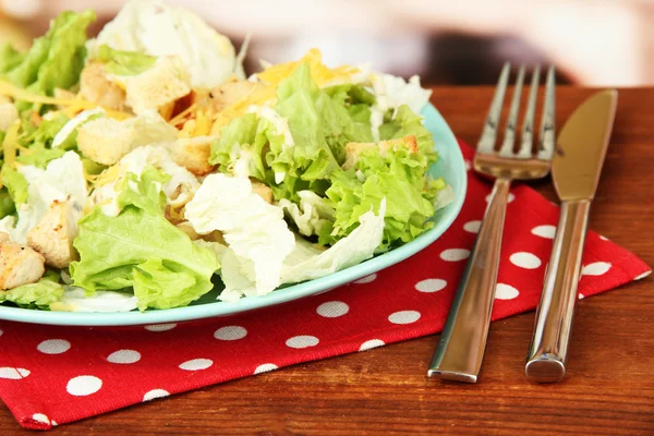Salada Caesar em prato azul, em fundo brilhante — Fotografia de Stock