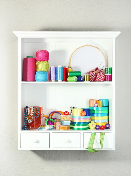 Beautiful white shelves with thread and material for handicrafts — Stock Photo, Image