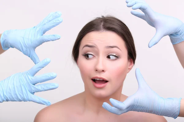 Rubber gloves touching face of  woman — Stock Photo, Image