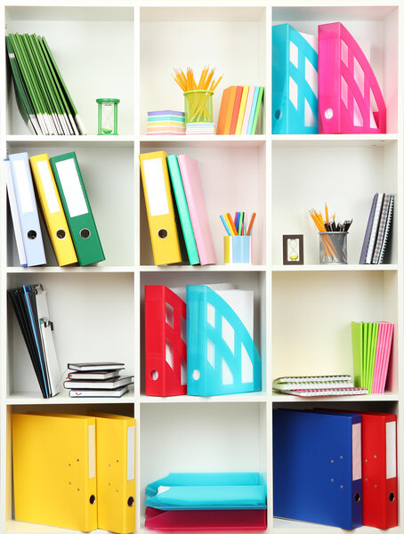 White office shelves with different stationery, close up