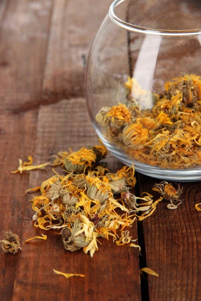 Dried herb in glass container on wooden table close-up — Stock Photo, Image