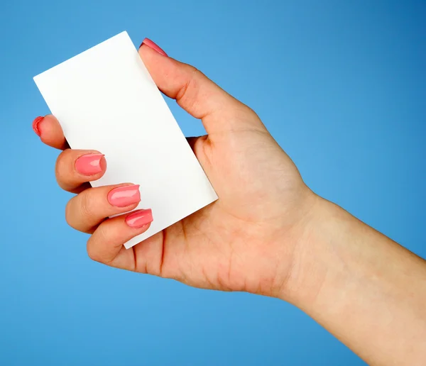 Female hand holding business card, on color background — Stock Photo, Image