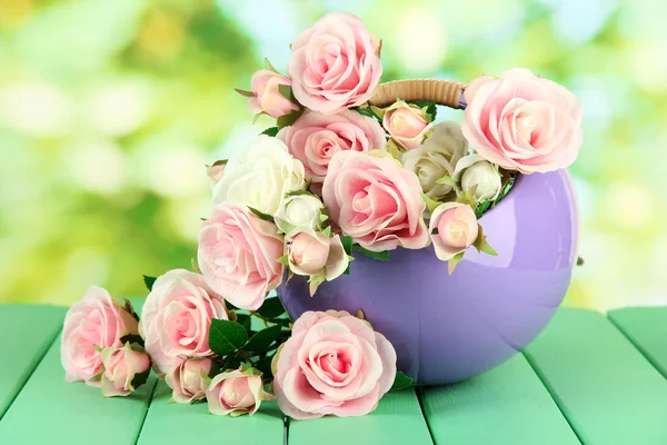 Pot with flowers on a wooden table on the nature background — Stock Photo, Image