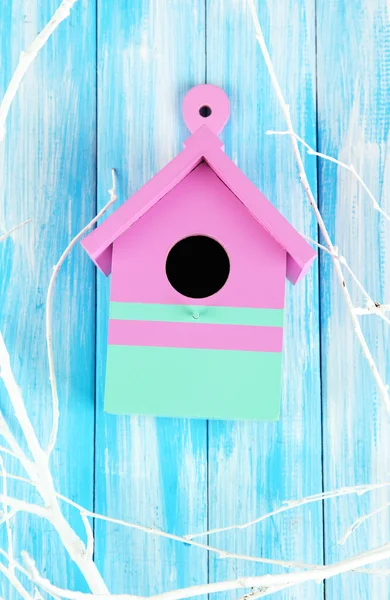 Decorative nesting box with color branches, on color wooden background — Stock Photo, Image