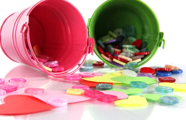 Colorful buttons strewn from buckets close-up — Stok fotoğraf