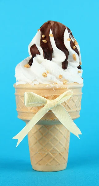 Tasty ice cream with chocolate, on blue background — Stock Photo, Image