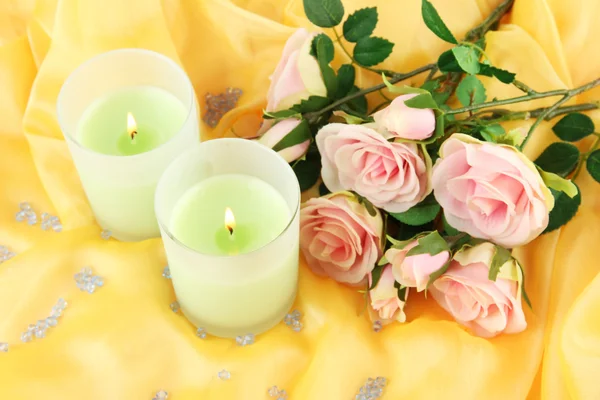 Candles on a yellow fabric close-up Stock Photo
