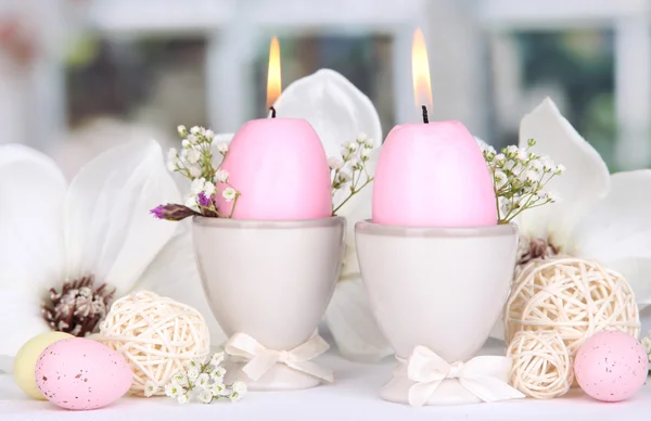 Easter candles with flowers on window background Royalty Free Stock Photos