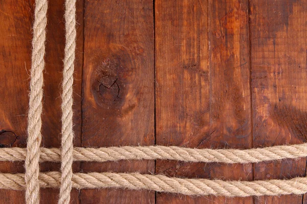 Frame composed of rope on wooden background — Stock Photo, Image