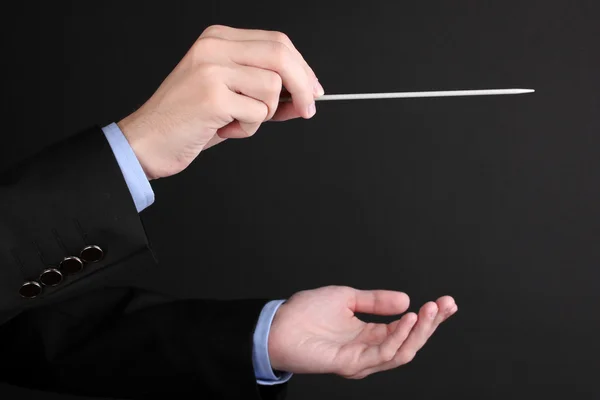 Music conductor hands with baton isolated on black — Stock Photo, Image