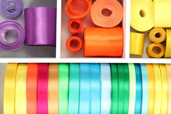Bright silk ribbons in white wooden box, close up — Stock Photo, Image