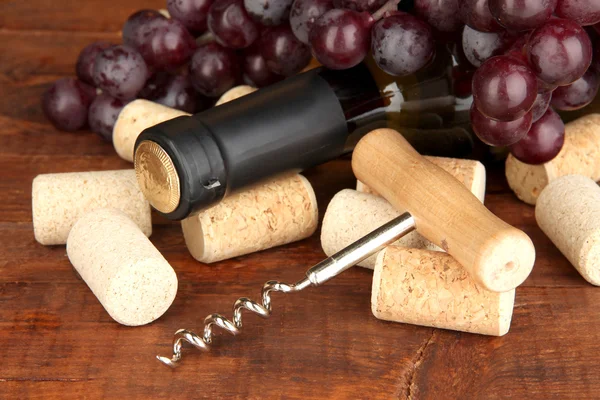 Wine and corks on wooden table — Stock Photo, Image