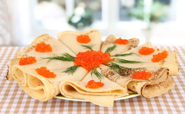 Delicious pancakes with red caviar on table in room — Stock Photo, Image