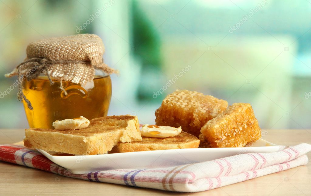 white bread toastwith honey on plate in cafe