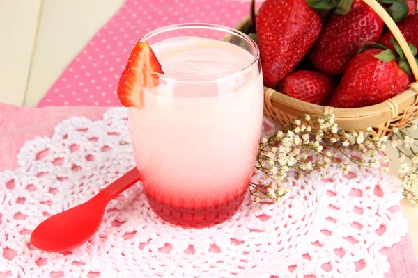 Delicious strawberry yogurt in glass on wooden table close-up — Stock Photo, Image