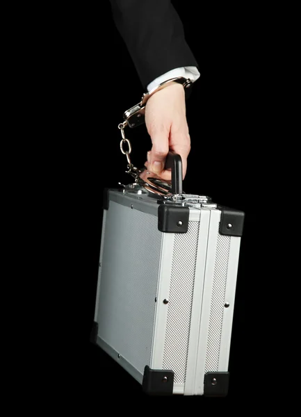 Hand with handcuff and suitcase, isolated on black — Stock Photo, Image