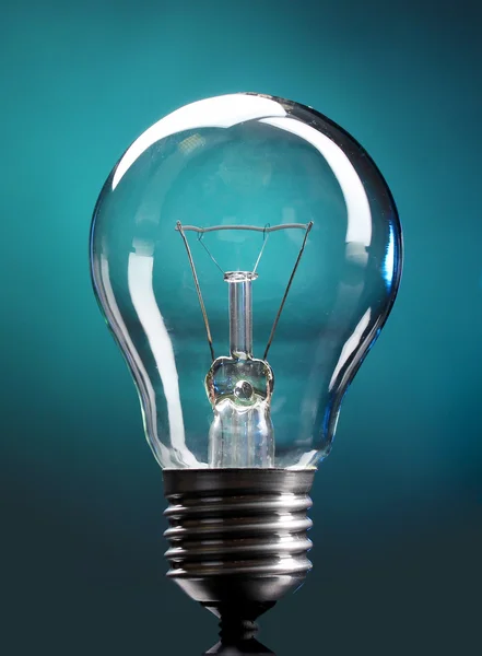 Light bulb on blue background — Stock Photo, Image