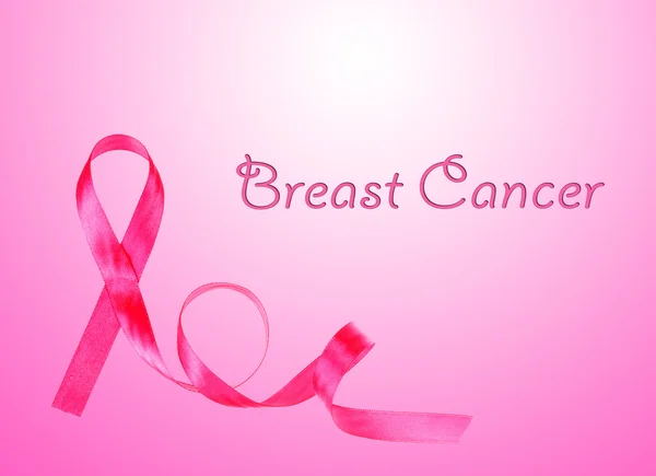 Pink breast cancer ribbon on pink background — Stock Photo, Image