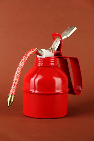 Red oil can, on color background — Stock Photo, Image