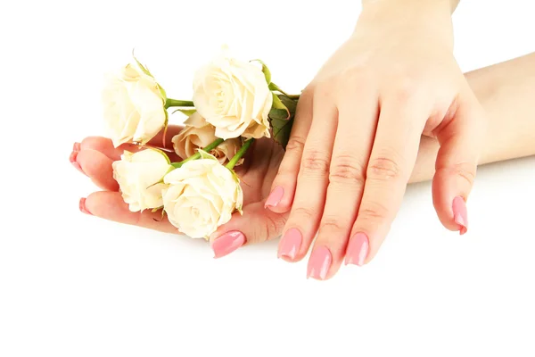 Manos de mujer con manicura rosa y flores, aisladas en blanco —  Fotos de Stock