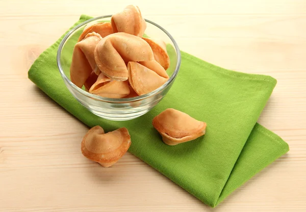 Fortune cookies in bowl, on wooden table — Stock Photo, Image