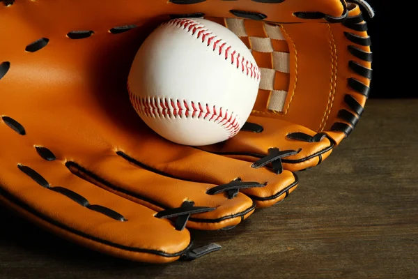 Baseball glove and ball on dark background — Stock Photo, Image