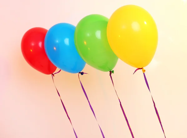 Four bright balloons on light background — Stock Photo, Image