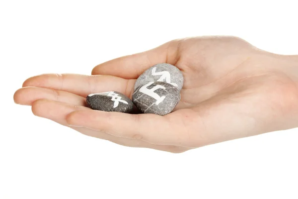 Fortune telling with symbols on stone in hand isolated on white — Stock Photo, Image