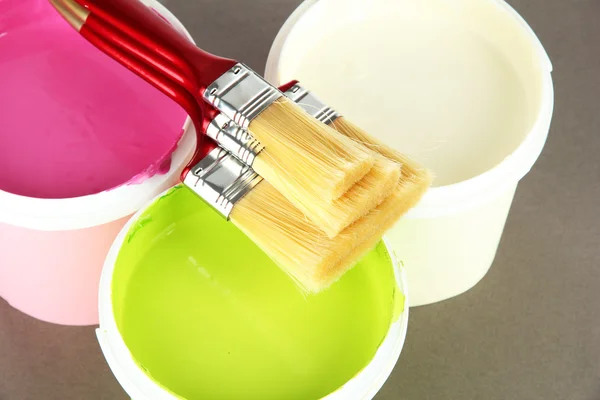 Set for painting: paint pot, brushes on grey background — Stock Photo, Image