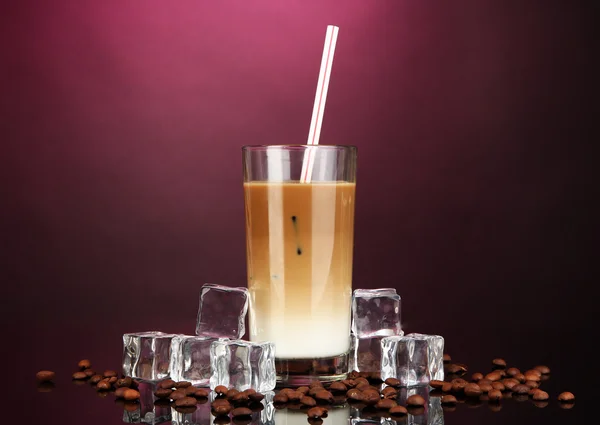 Cold coffee with ice in glass on color background — Stock Photo, Image