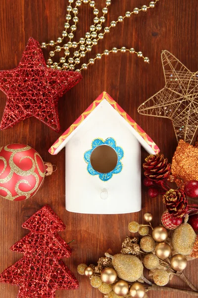 Nesting box and Christmas decorations on wooden background — Stock Photo, Image