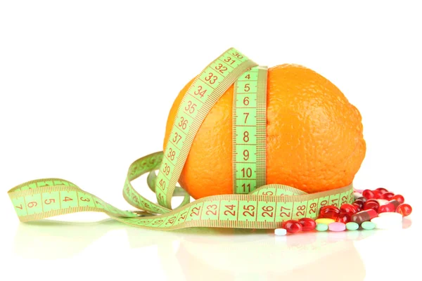 Orange with measuring tape and multicolor pills, isolated white — Stock Photo, Image