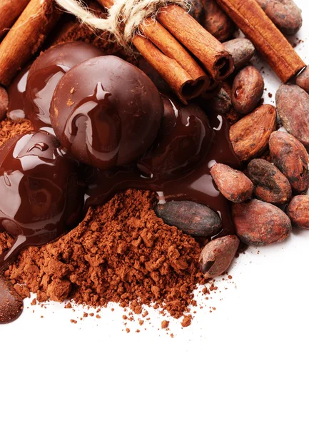 Composition of chocolate sweets, cocoa and spices, isolated on white — Stock Photo, Image