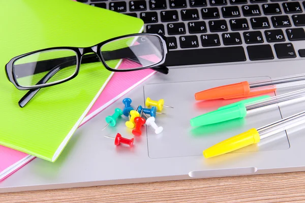 Laptop with stationery on table — Stock Photo, Image