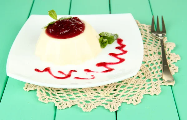 Panna Cotta with raspberry sauce, on color wooden background — Stock Photo, Image