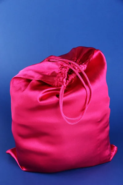 Bright pink bag on blue background — Stock Photo, Image