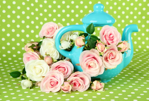 Pot with flowers on a green fabric background — Stock Photo, Image