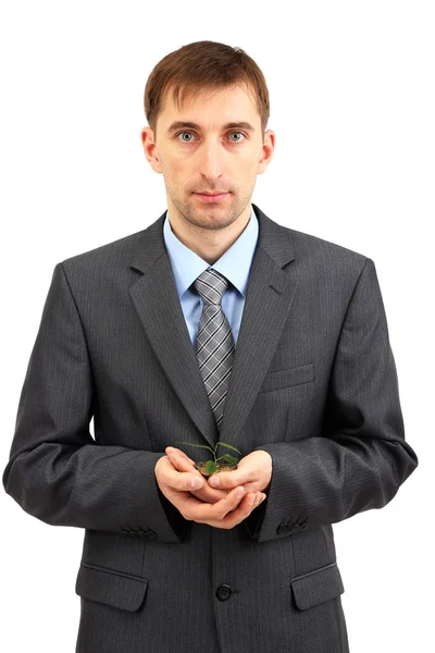 Giovane uomo d'affari con monete e pianta isolata su whit — Foto Stock