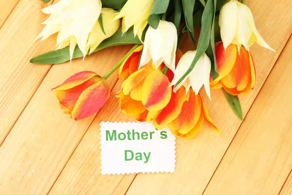 Beautiful white and orange tulips on wooden background — Stock Photo, Image