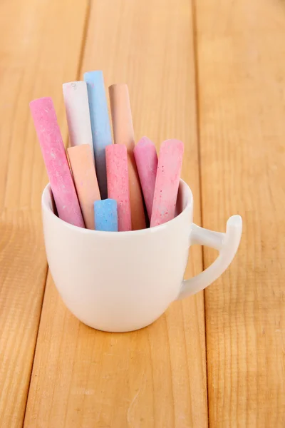 Colorful chalk in cup on table — Stok fotoğraf