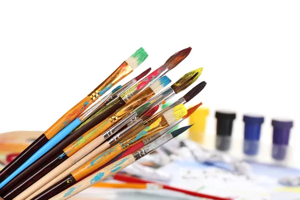 Many brush in paint on bright background — Stock Photo, Image