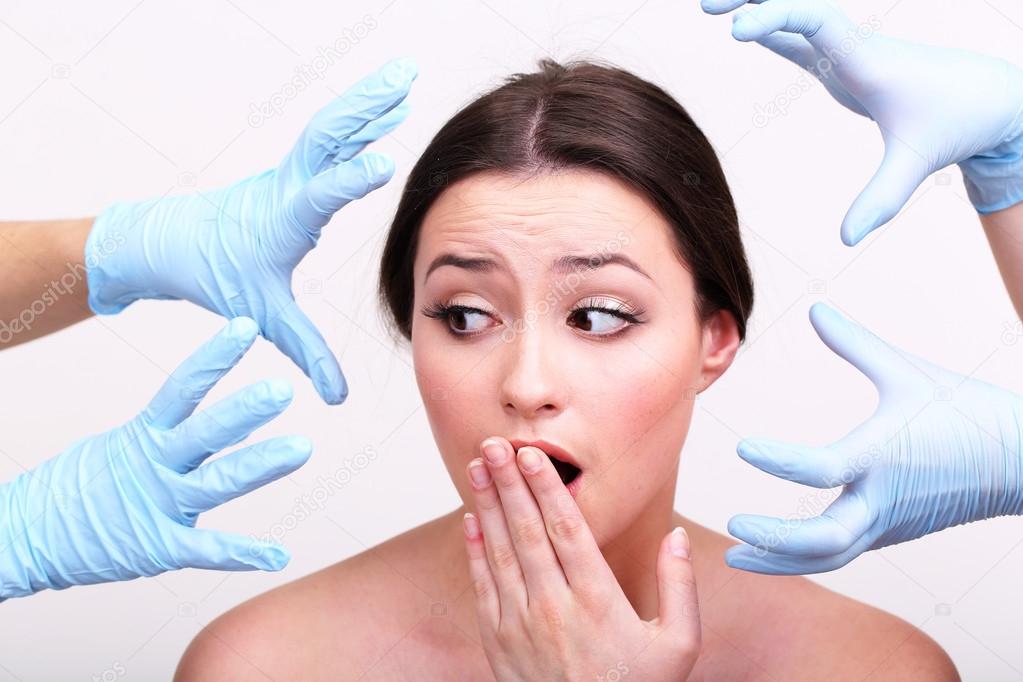 Rubber gloves touching face of young woman close up