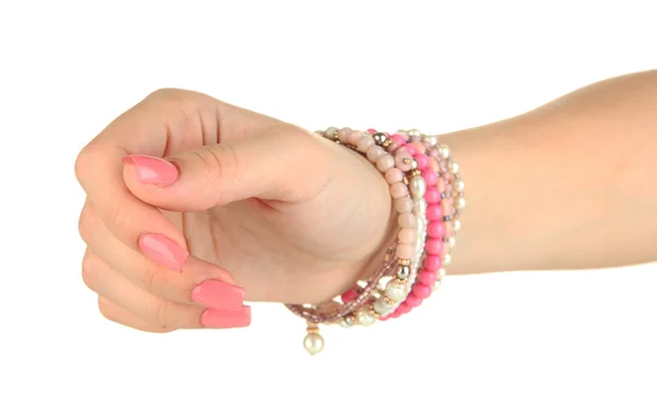 Mano femenina con manicura rosa y brazalete brillante, aislada en blanco — Foto de Stock